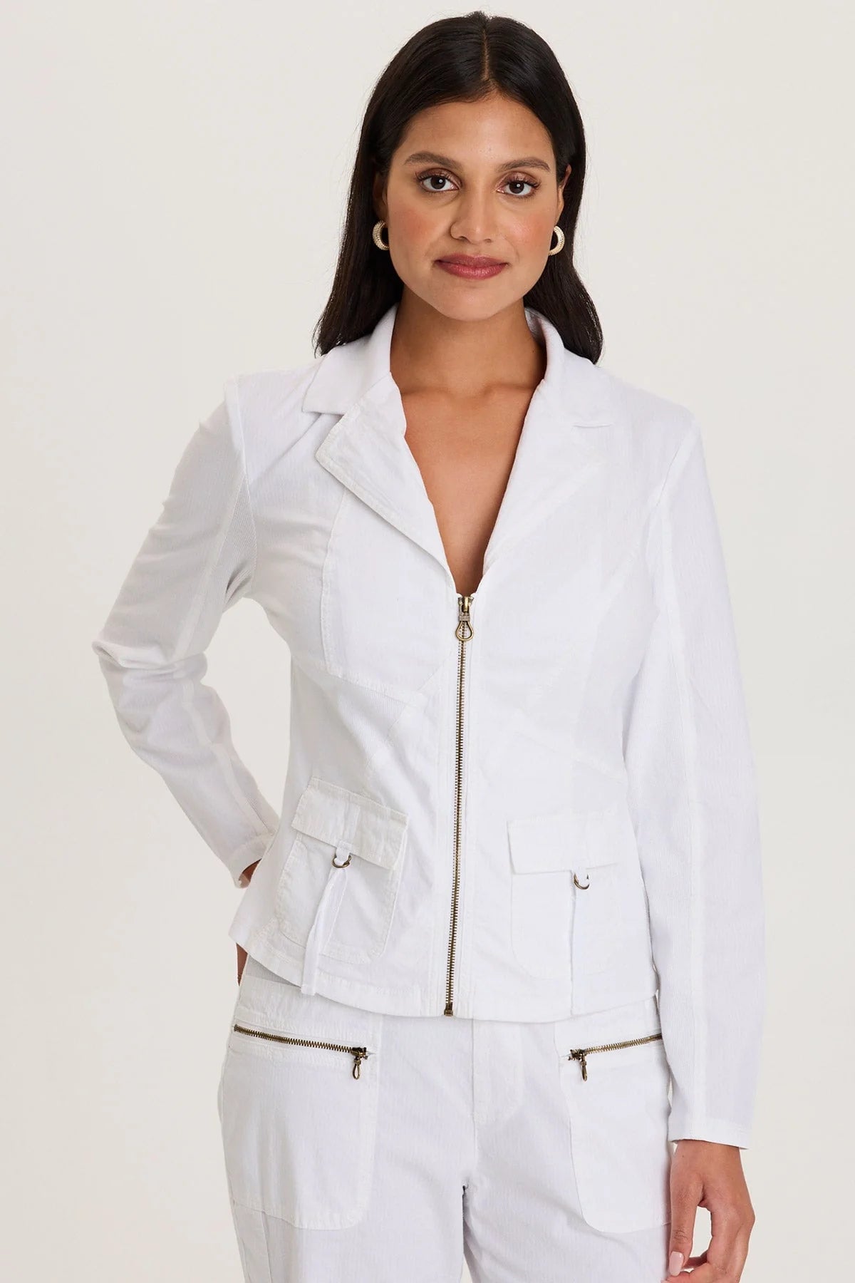 Front view of a woman wearing a structured white cotton fleece zip-up jacket with front pockets and a cozy mock neckline.
