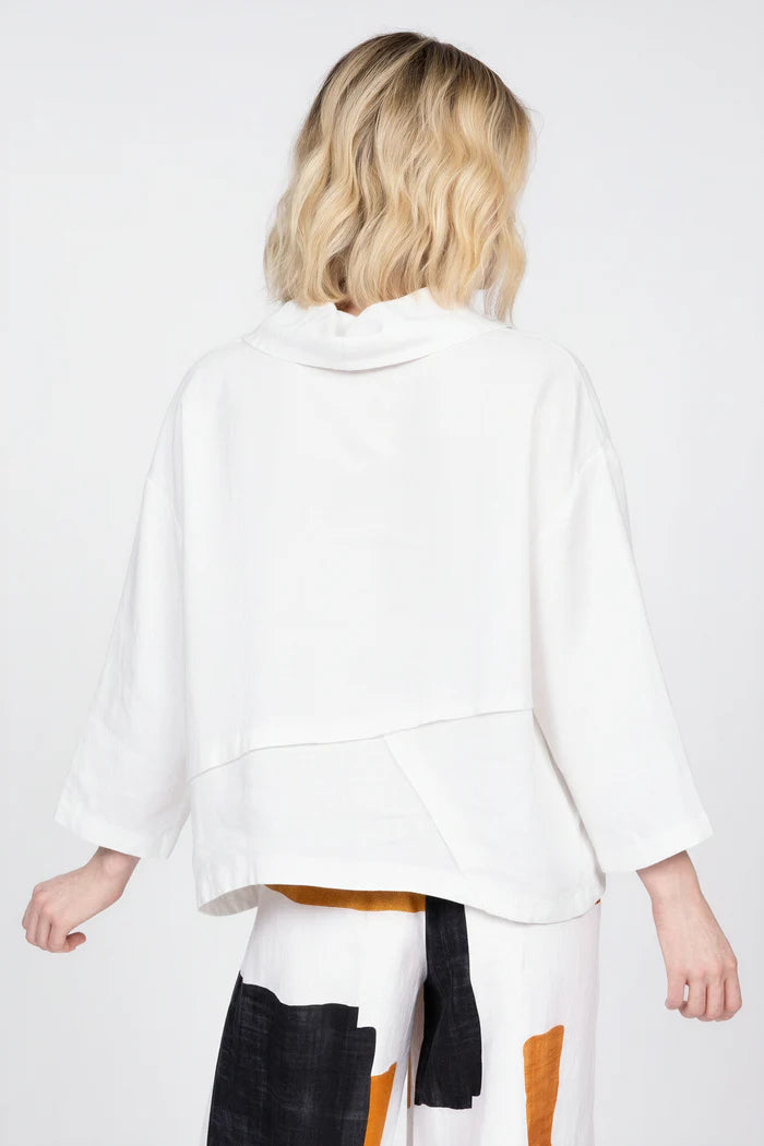 Rear view of a woman wearing the white elegant seamed cowl top in 100% linen