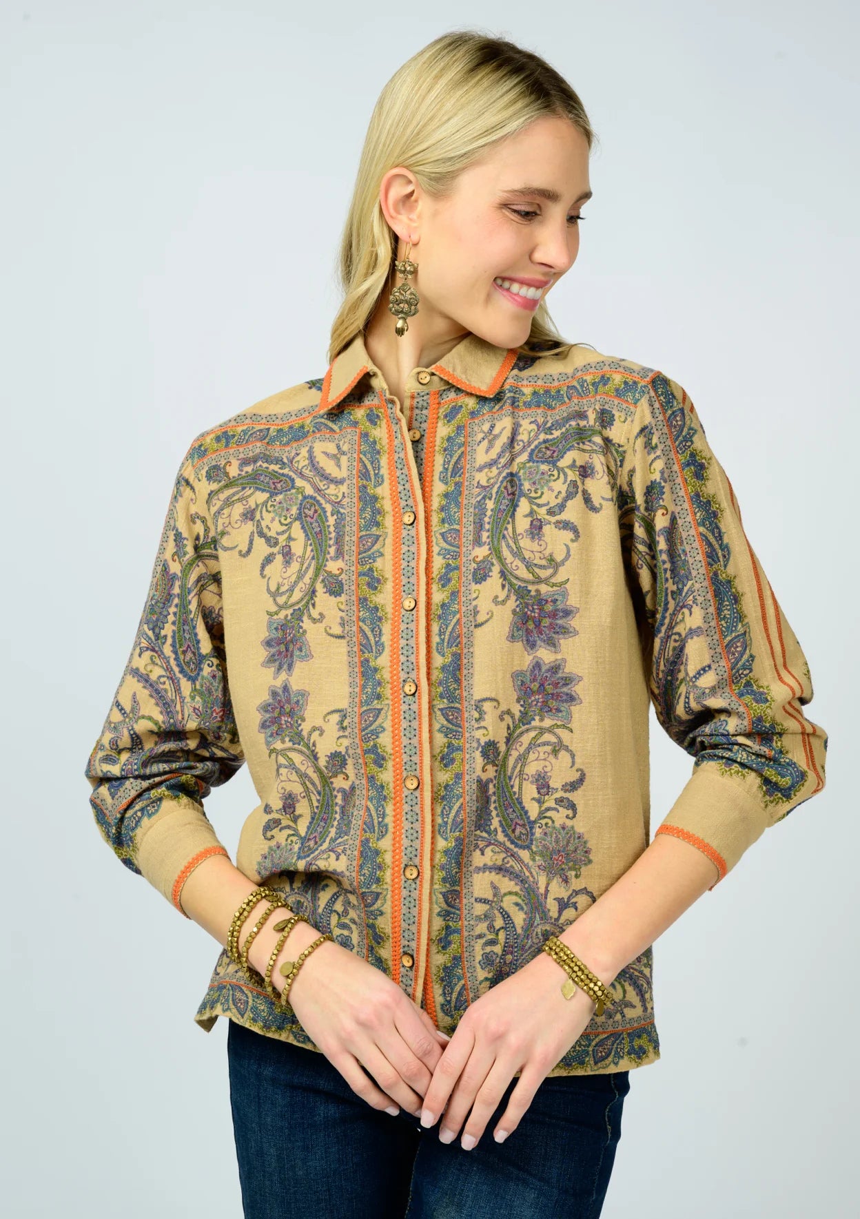 Woman wearing a patterned shirt with a plain background