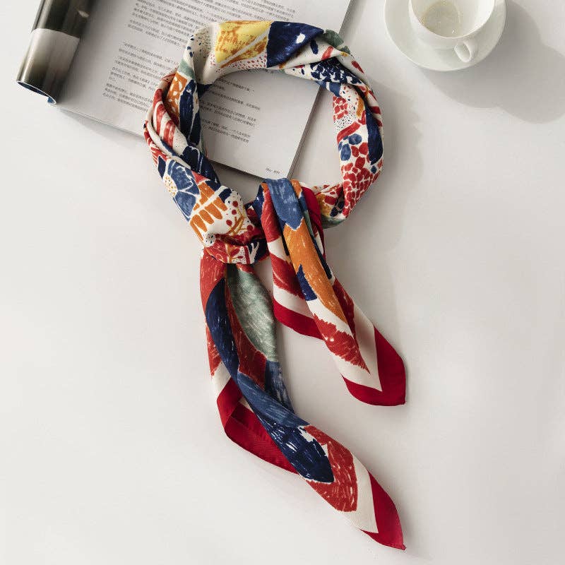 A luxuriously soft square scarf featuring a colorful and vibrant graffiti floral design, styled artfully.