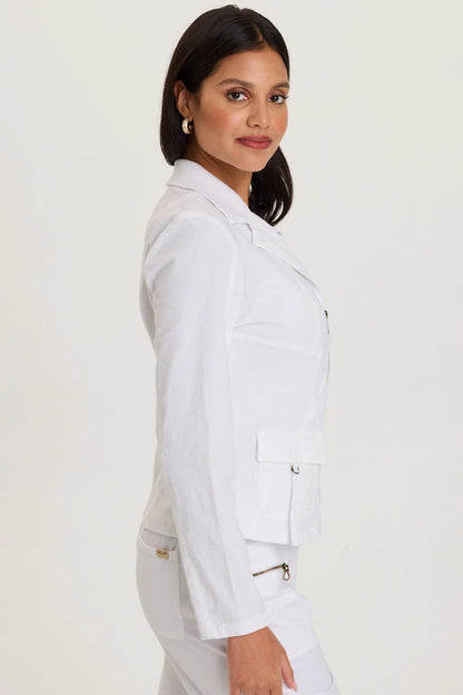 Side view of a woman wearing a structured white cotton fleece zip-up jacket with front pockets and a cozy mock neckline.