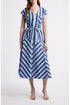A woman wearing a blue and white multi-directional striped midi dress with a V-neckline, short cap sleeves, and a matching fabric tie belt.