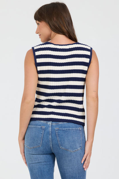 Rear view of a woman wearing a navy and white striped sleeveless sweater with blue jeans on a light gray background