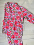 A pink and red floral hand-block printed 100% cotton pajama set with a button-down top and matching pants.
