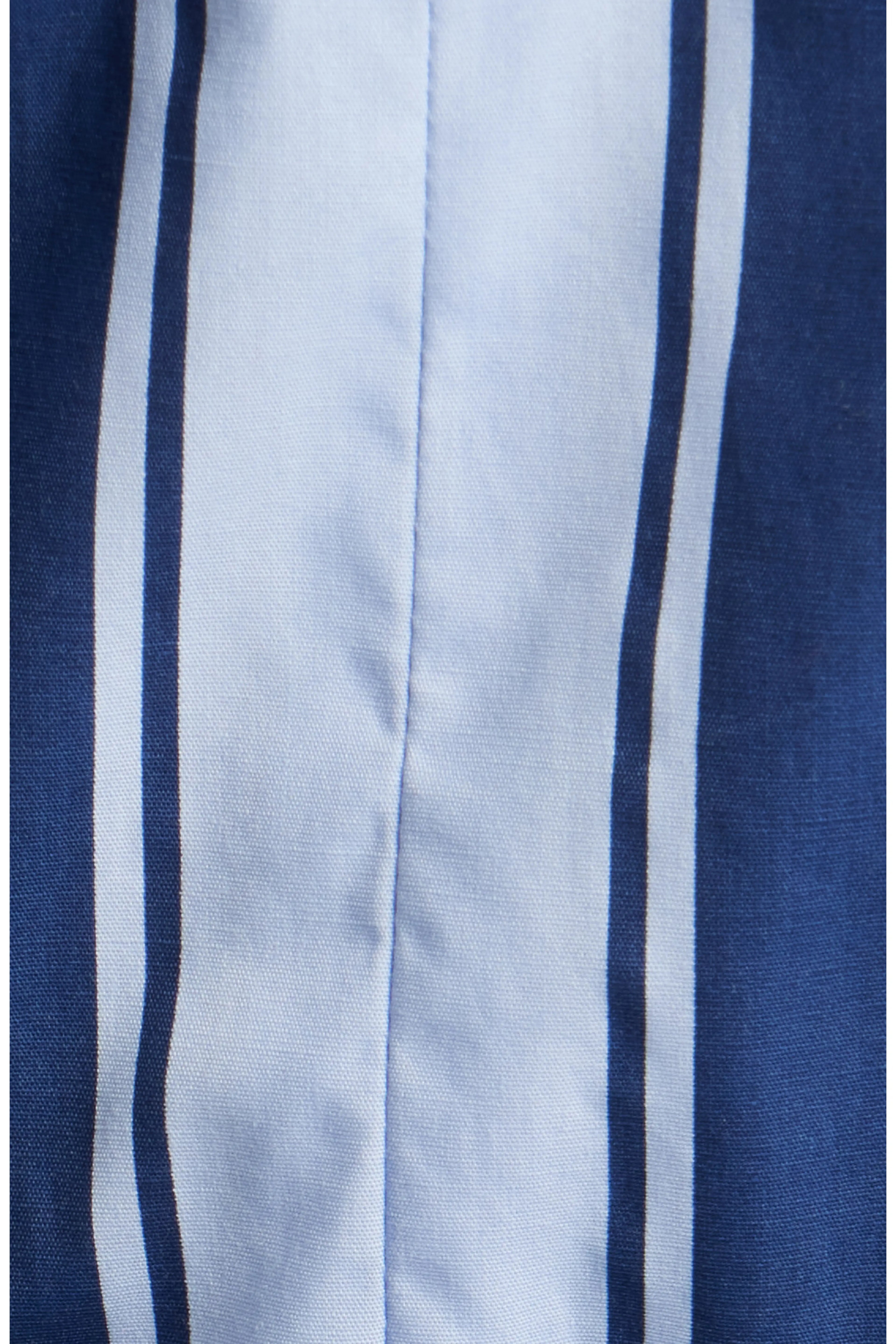 Close up view of a blue and white multi-directional striped fabric.