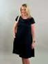 Blonde woman smiling while wearing a classic black 100% linen cowl-neck midi dress with a tan crossbody bag.