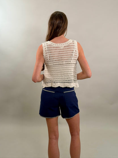 Rear view of a blank cream embroidered tank and navy blue shorts featuring unique white contrast stitching on the pocket trim and hem.