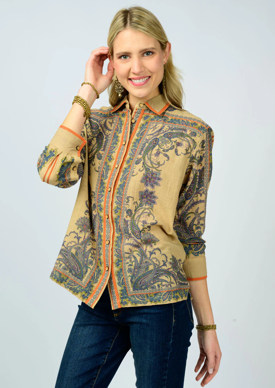 Woman wearing a blouse jacket on a plain background