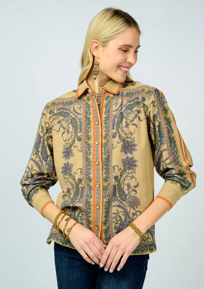 Woman wearing a patterned shirt with a plain background