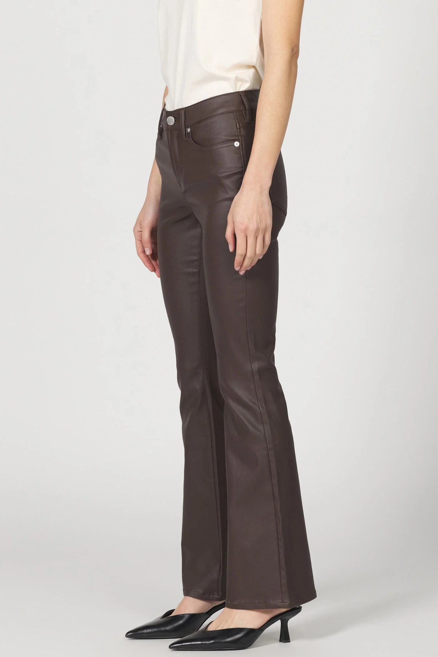 Brown leather pants worn by a person on a white background
