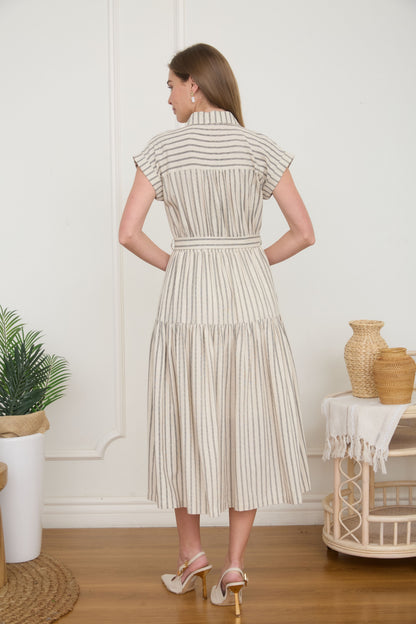 Rear view of a woman wearing a light taupe and cream vertically striped midi shirt dress with a tie belt, short cap sleeves, and high heels.