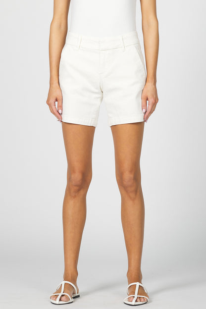 Front view of a woman wearing off-white mid-low rise casual shorts with a clean hem and white sandals.