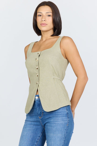 Side view of a woman wearing a sage green linen-blend sleeveless vest with a button front and blue jeans.