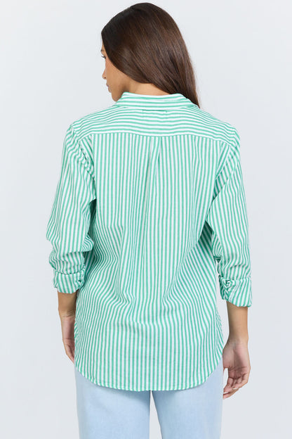 Rear view of a woman wearing a green and white vertical striped long-sleeve cotton button-up shirt with light blue jeans.