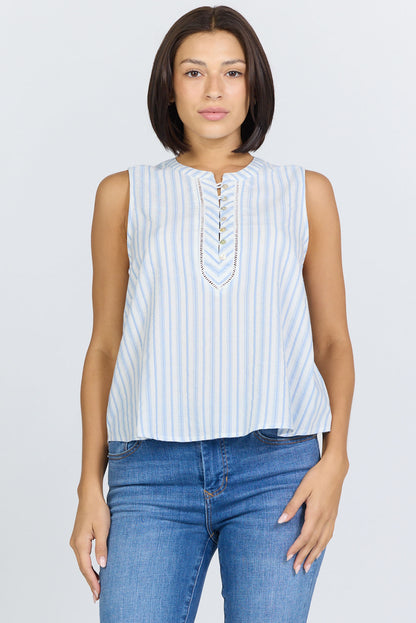 Front view of a woman with a dark bob haircut wearing a sleeveless blue and white striped cotton-blend top with a button-up Henley neck and blue jeans.