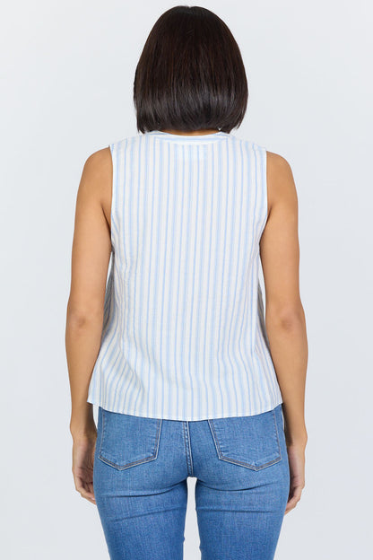 Rear view of a woman with a dark bob haircut wearing a sleeveless blue and white striped cotton-blend top with a button-up Henley neck and blue jeans.