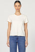 Front view of a woman wearing a white classic short-sleeve crew neck cotton jersey t-shirt paired with denim