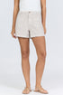 Front view of a woman wearing oatmeal-colored high-rise linen-blend shorts with patch pockets and matching tan strappy sandals.
