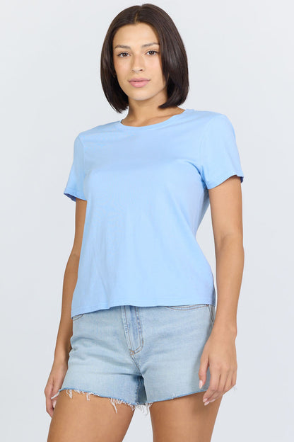 Side view of a woman wearing a blue classic short-sleeve crew neck cotton jersey t-shirt paired with denim
