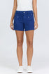 Front view of a woman wearing the mid-high rise comfort stretch shorts in blue with white sneakers