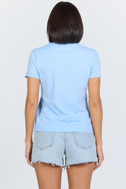 Rear view of a woman wearing a blue classic short-sleeve crew neck cotton jersey t-shirt paired with denim