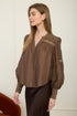 A woman wearing a romantic, flowy espresso brown long-sleeve peasant blouse with detailed ladder-lace inserts across the chest and sleeves.